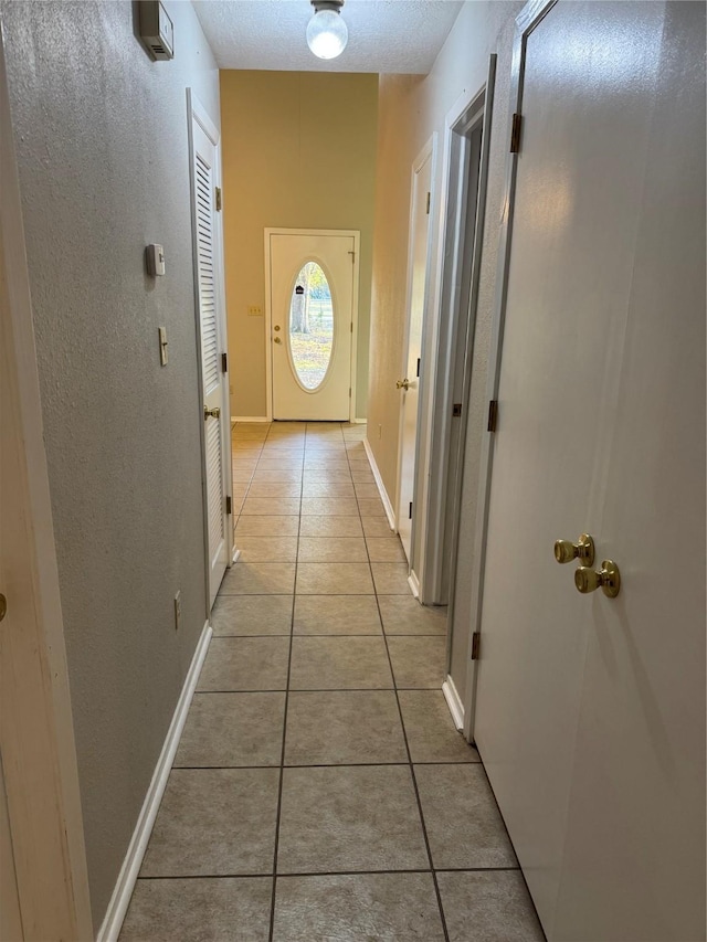 hall with light tile patterned floors