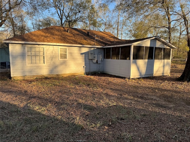 view of property exterior with a sunroom