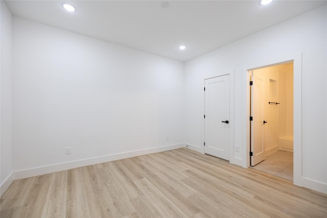 spare room featuring light wood-type flooring