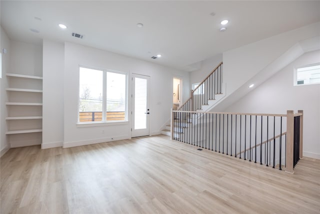 interior space featuring built in features and light wood-type flooring