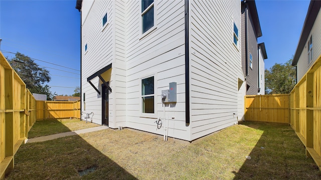 view of side of home featuring a yard