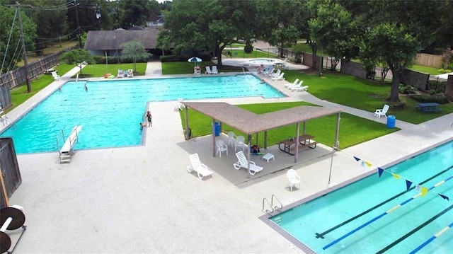 view of swimming pool featuring a yard and a patio area