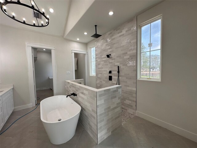 bathroom featuring vaulted ceiling, shower with separate bathtub, and vanity