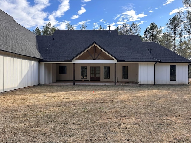 rear view of house with a lawn and a patio area