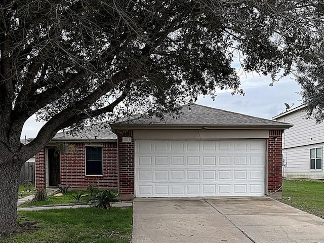 single story home featuring a garage and a front lawn