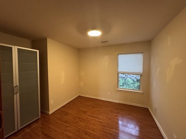 unfurnished bedroom featuring dark hardwood / wood-style flooring