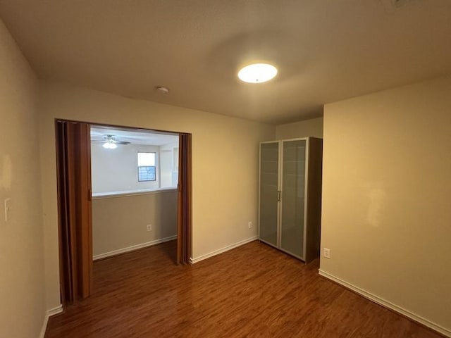 empty room with dark wood-type flooring