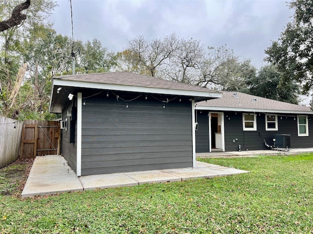 back of property featuring a patio area, a lawn, and central air condition unit