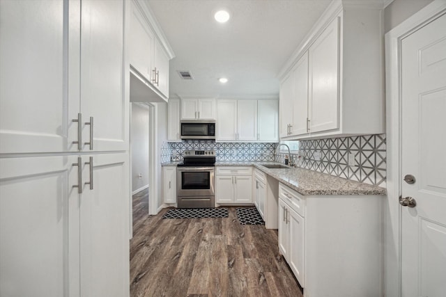 kitchen featuring white cabinetry, stainless steel appliances, dark hardwood / wood-style floors, light stone countertops, and sink