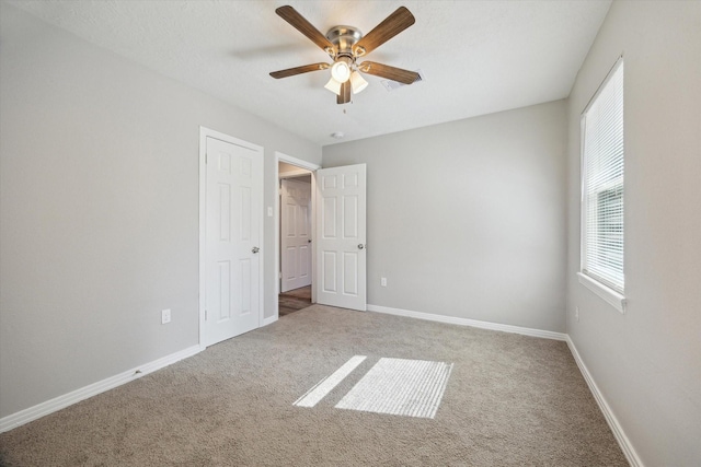 unfurnished bedroom with ceiling fan and carpet flooring