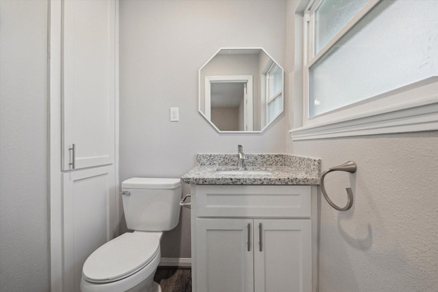 bathroom with toilet and vanity