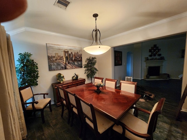 dining space featuring dark hardwood / wood-style flooring and crown molding