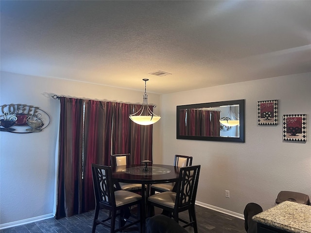 dining space featuring dark wood-type flooring