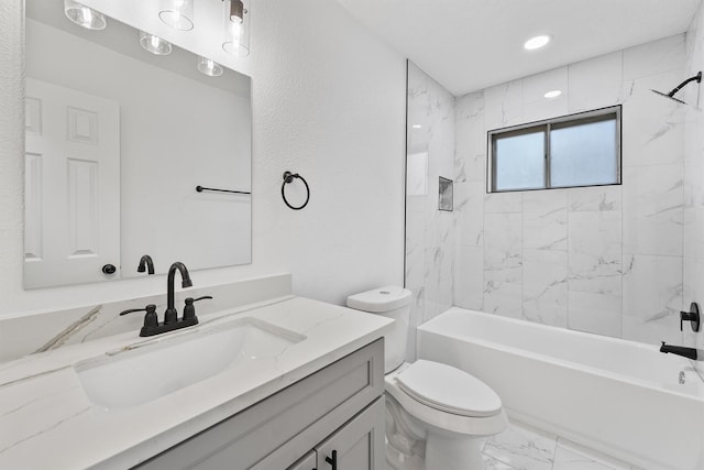 full bathroom featuring vanity, toilet, and tiled shower / bath