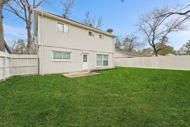 back of house with a lawn