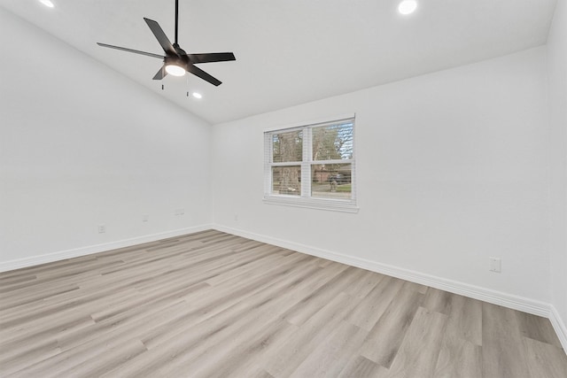 spare room with ceiling fan, light hardwood / wood-style flooring, and vaulted ceiling