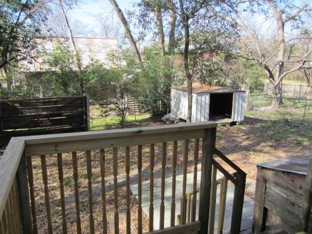 wooden terrace with a storage shed