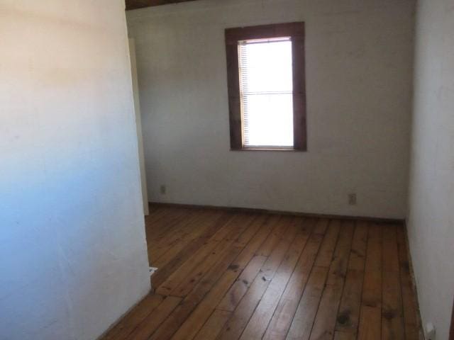 unfurnished room featuring hardwood / wood-style flooring