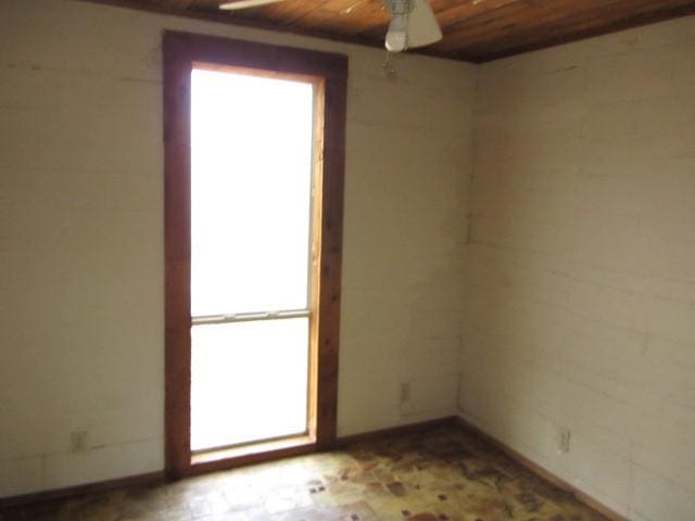 empty room with ceiling fan and wood ceiling