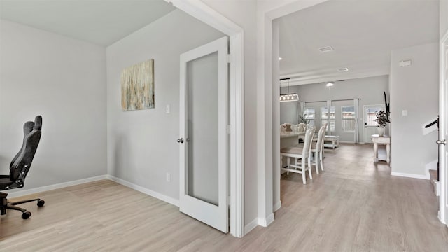 office area with french doors and light hardwood / wood-style floors