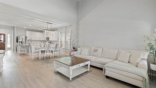 living room with light wood-type flooring and sink