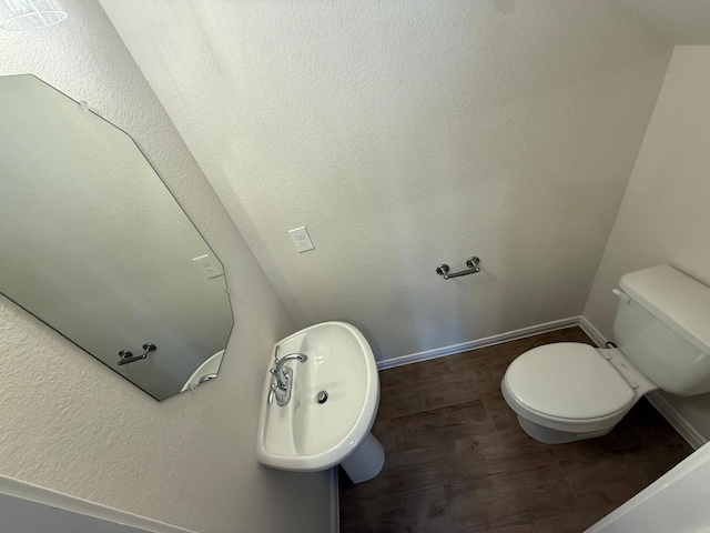 bathroom with wood-type flooring and toilet