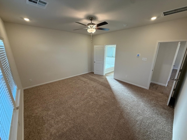 carpeted empty room featuring a wealth of natural light and ceiling fan