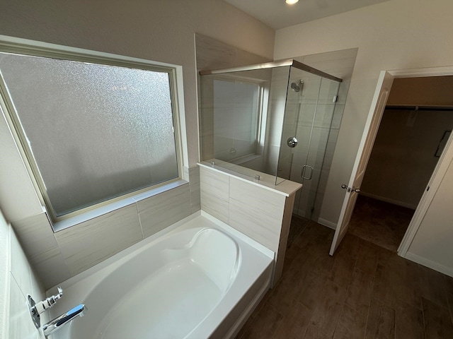 bathroom with plus walk in shower and wood-type flooring