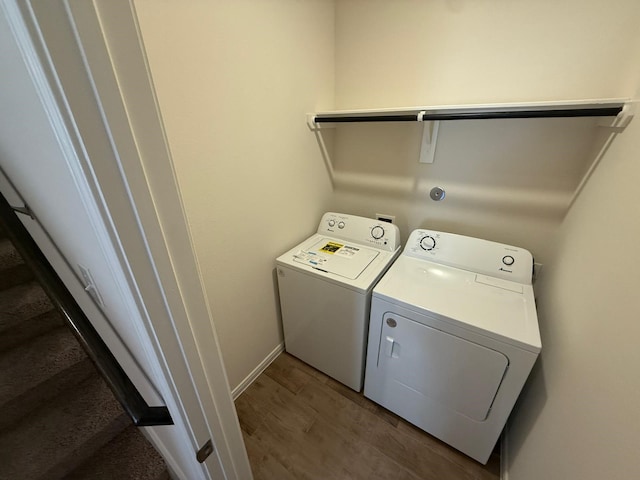 laundry area with separate washer and dryer and dark hardwood / wood-style floors