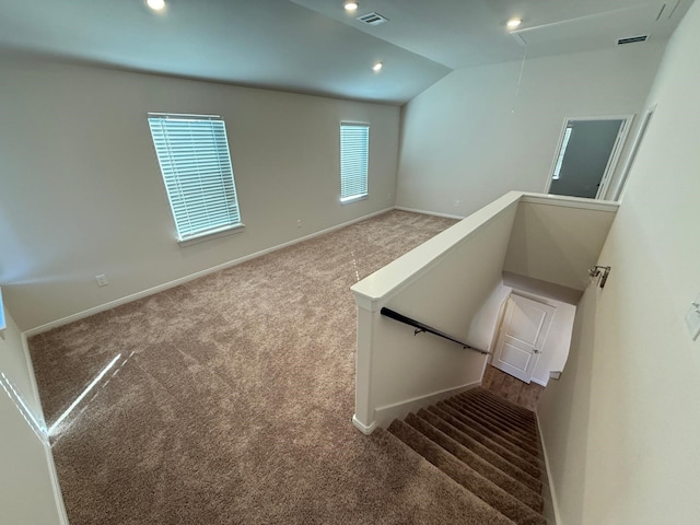 stairs with carpet floors and lofted ceiling