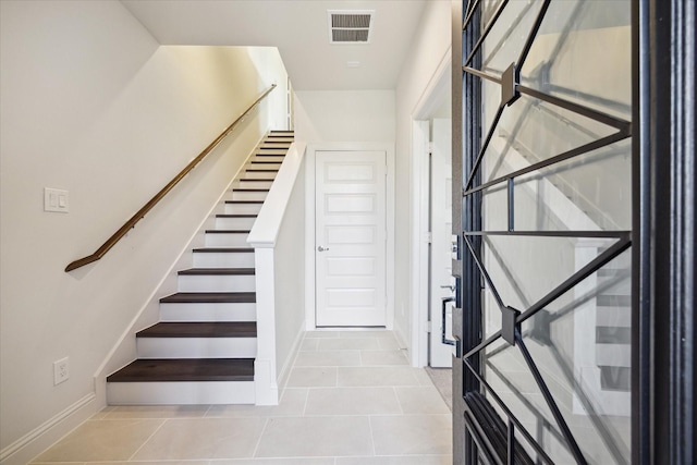 stairway featuring tile patterned floors