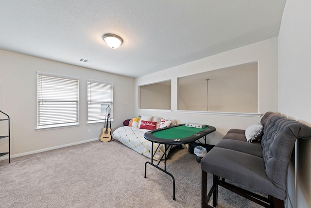 game room with carpet and a textured ceiling