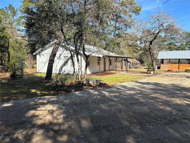 view of property exterior with an outdoor structure