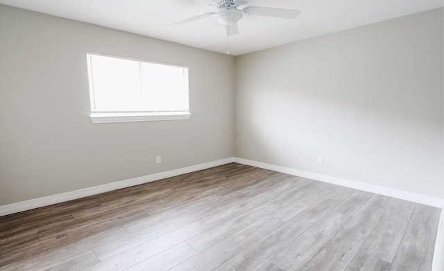 spare room featuring light wood-type flooring and ceiling fan