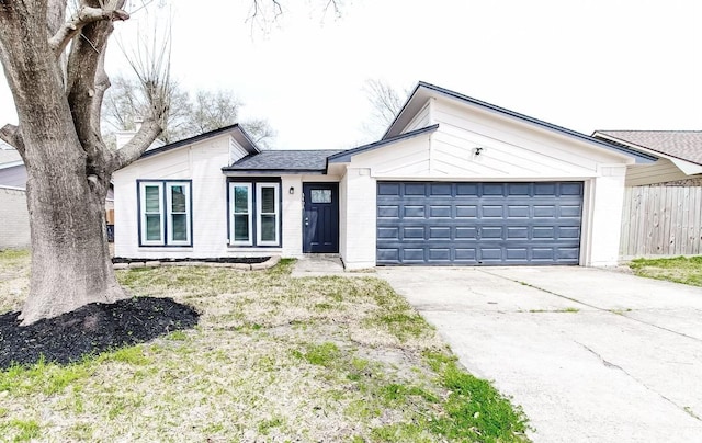 single story home with a front yard and a garage