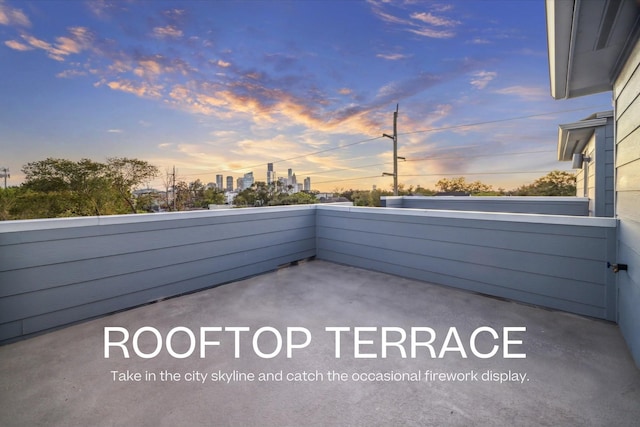 patio terrace at dusk with a balcony