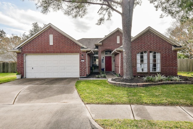 view of front of property featuring a garage and a front lawn