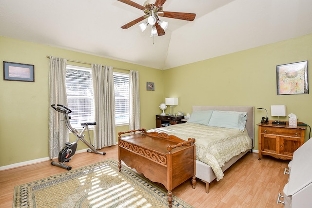 bedroom featuring ceiling fan, light hardwood / wood-style flooring, and vaulted ceiling