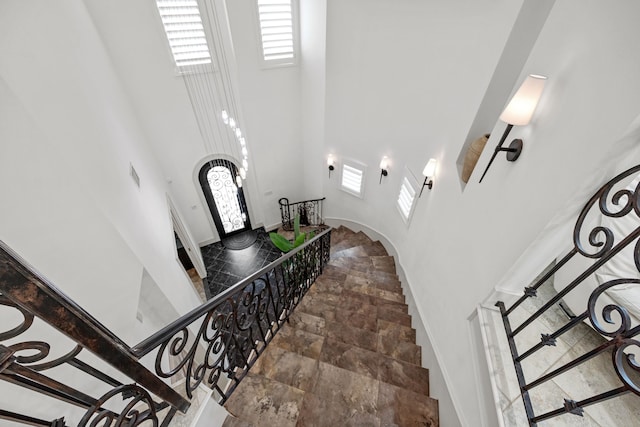 stairway featuring a high ceiling