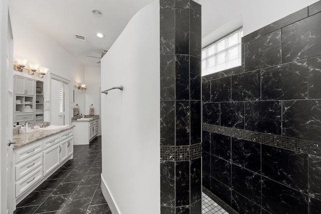 bathroom with vanity and a shower