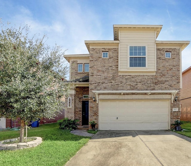 view of front of house with a front yard and a garage