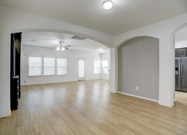 unfurnished living room featuring ceiling fan and light hardwood / wood-style flooring