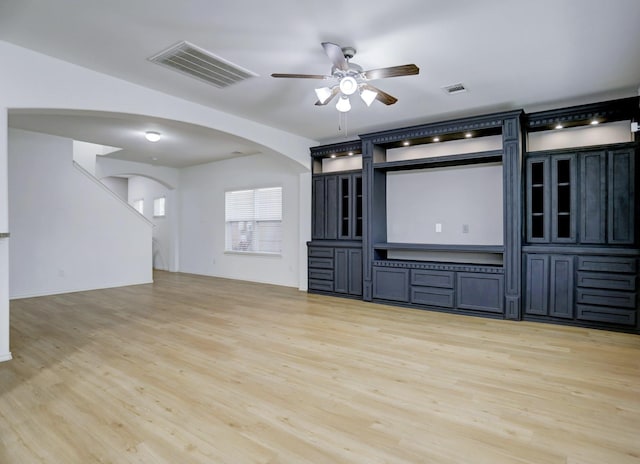 unfurnished living room with ceiling fan and light wood-type flooring