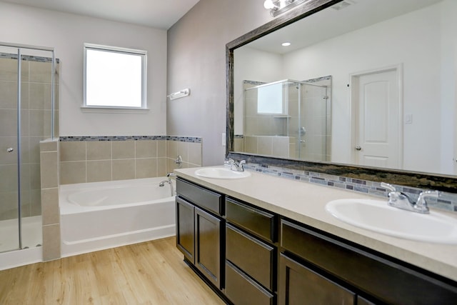 bathroom with decorative backsplash, vanity, wood-type flooring, and shower with separate bathtub