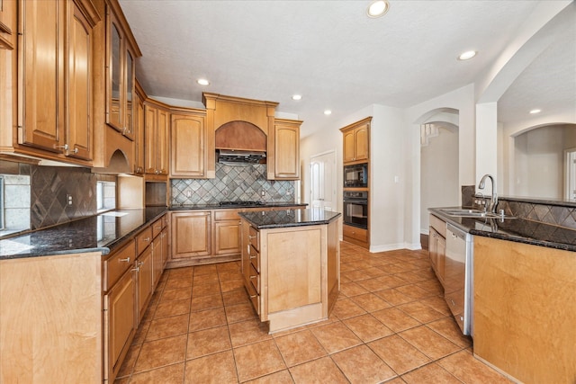 kitchen featuring sink, light tile patterned floors, decorative backsplash, and black appliances