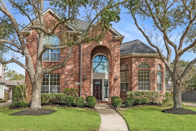 view of property featuring a front lawn