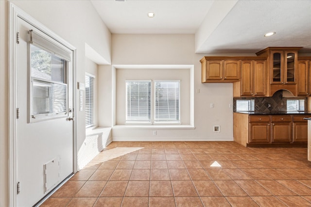 kitchen with light tile patterned flooring and decorative backsplash