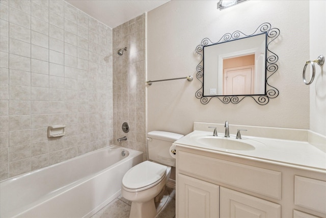 full bathroom with tiled shower / bath, vanity, and toilet