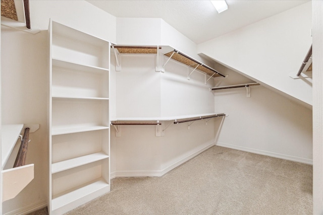 walk in closet featuring light carpet