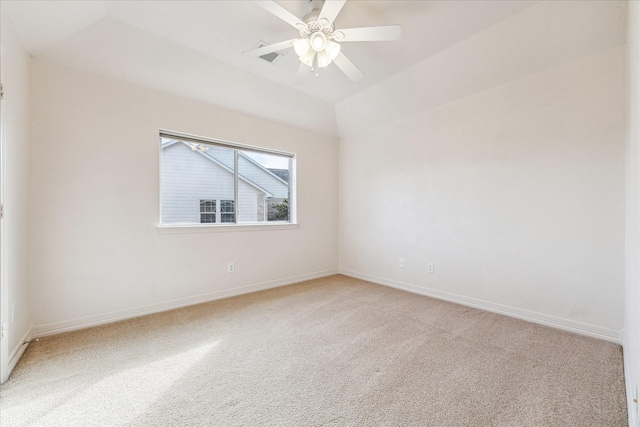 carpeted empty room with vaulted ceiling and ceiling fan